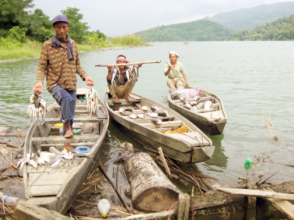 Fishermen returning home with their catch after a day’s work at River Doyang.